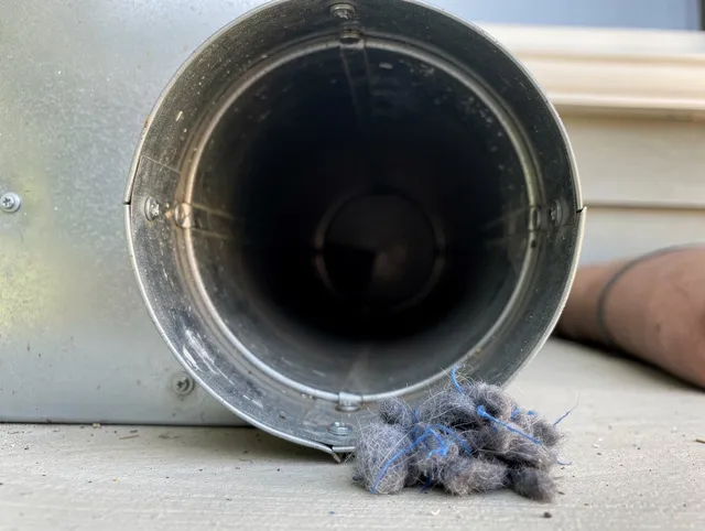 Port Orange Dryer Vent Cleaning technician using specialized equipment to clear severe dryer vent blockage in Port Orange